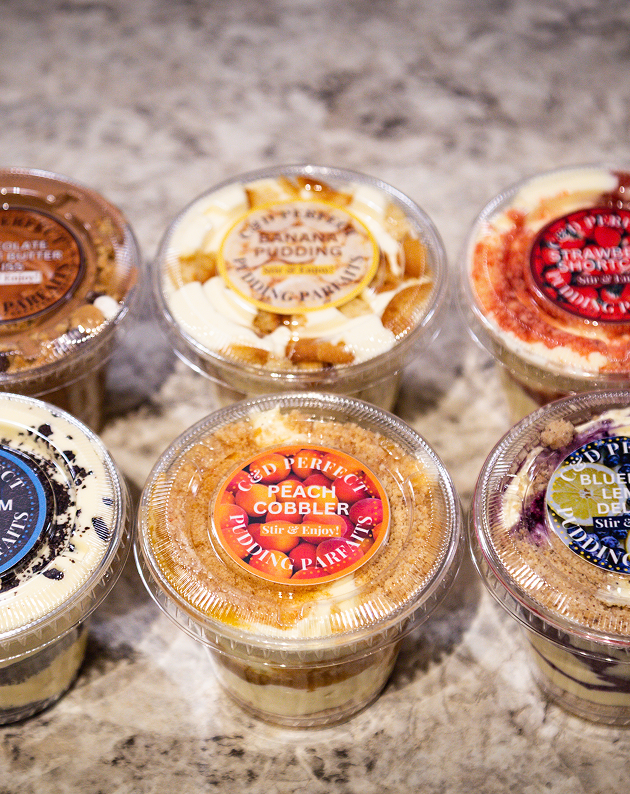 A lineup of labeled pudding parfait cups in six flavors