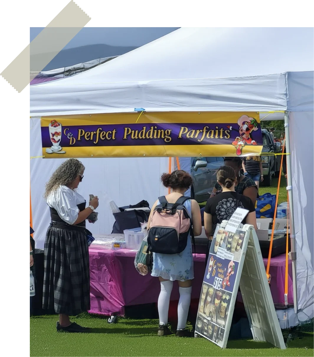 C&D Perfect Pudding Parfaits banner over a catering tent at an Alaska festival